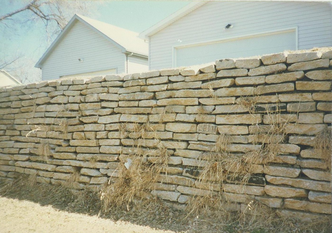 Before: failing stone wall