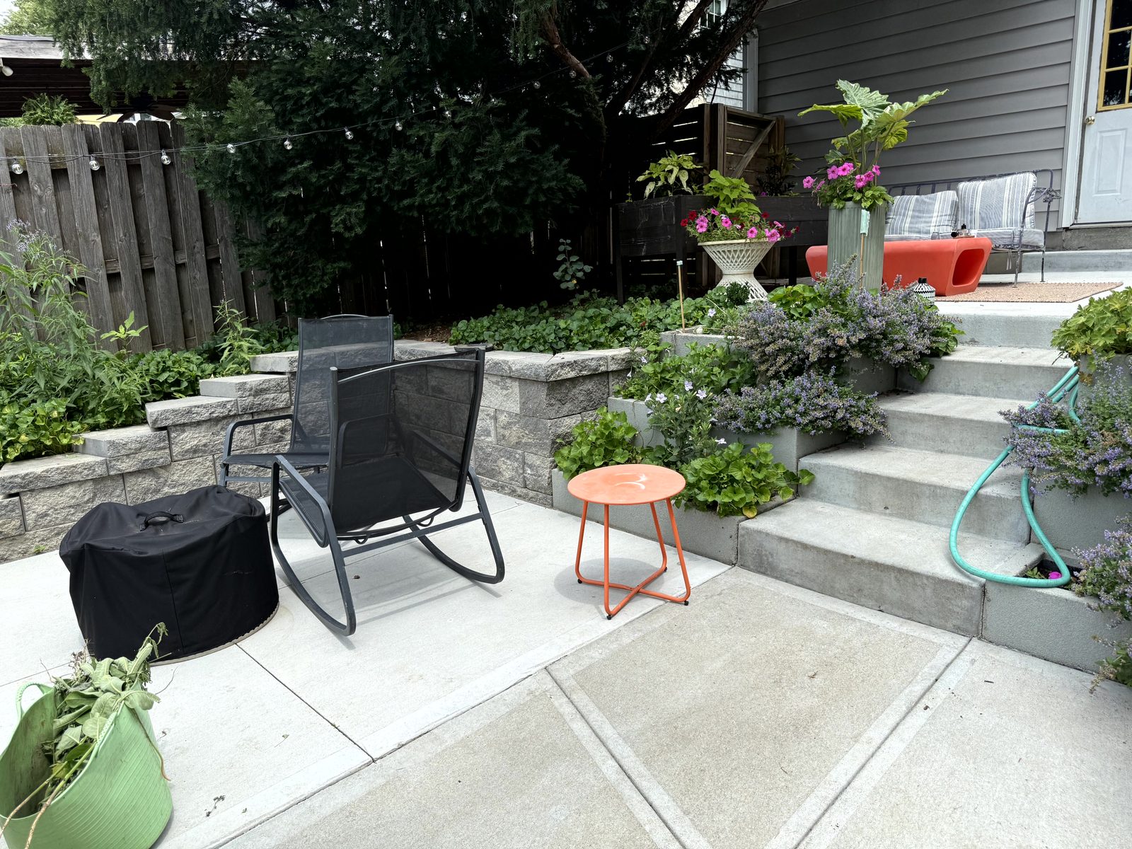 Block garden wall with concrete steps and flowers