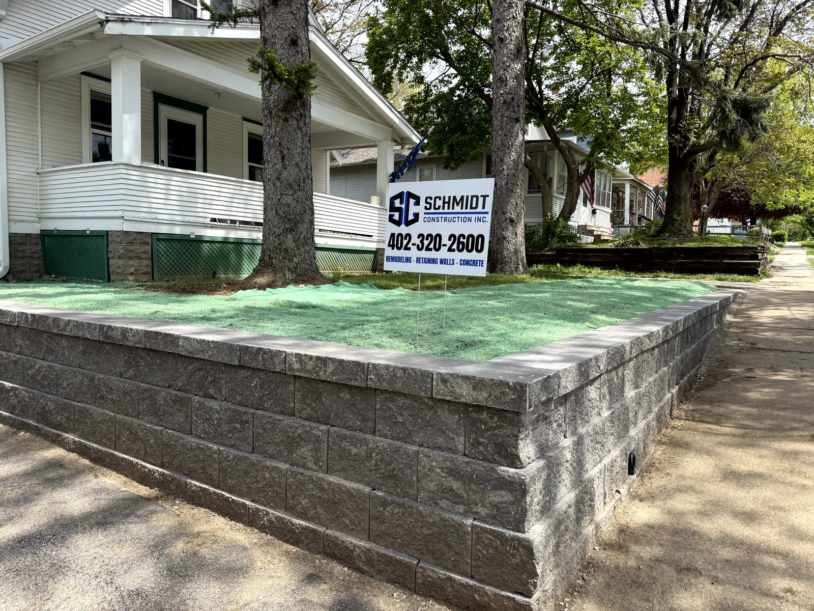 Schmidt Construction block wall with yard sign